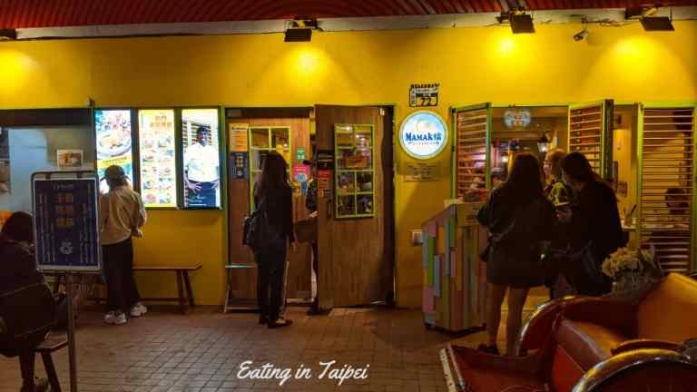 The bright yellow paint of Mamak makes it stand out on the side of the road in Eastern area. Lights bounce of the yellowness and make it look inviting.